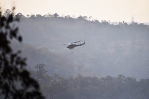 Threat Eases But Fire Still Burning